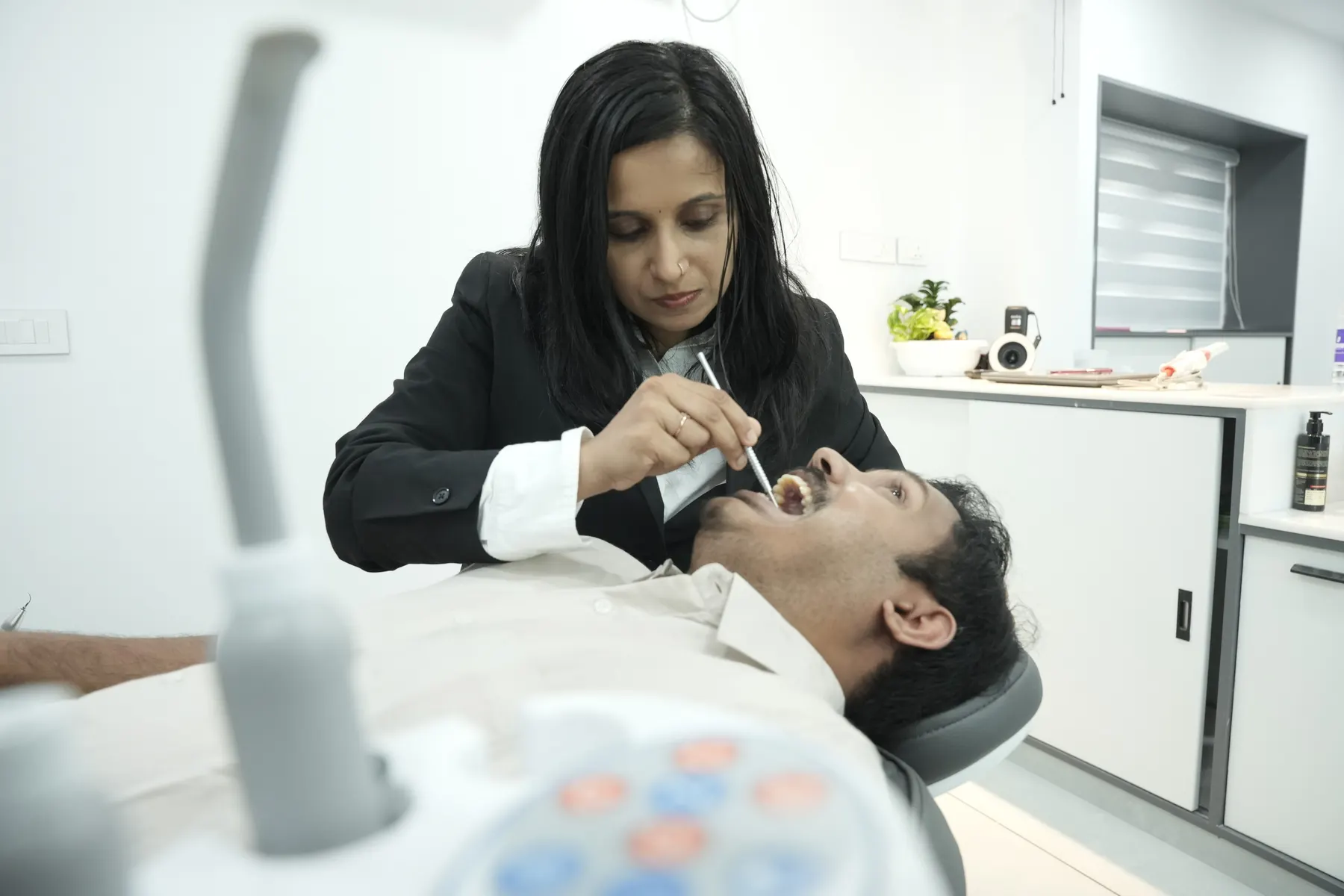 Dentist examining a patient at Dental Craft Vanchiyoor
