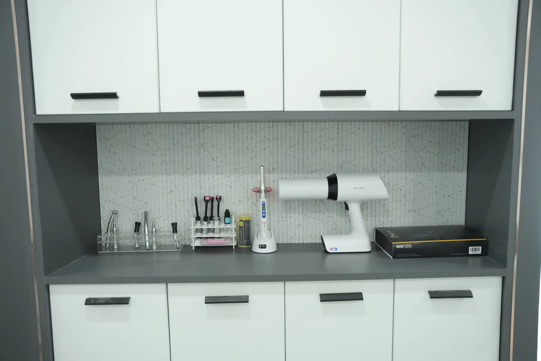 Instrument and imaging counter with white cabinets at Dental Craft Vanchiyoor