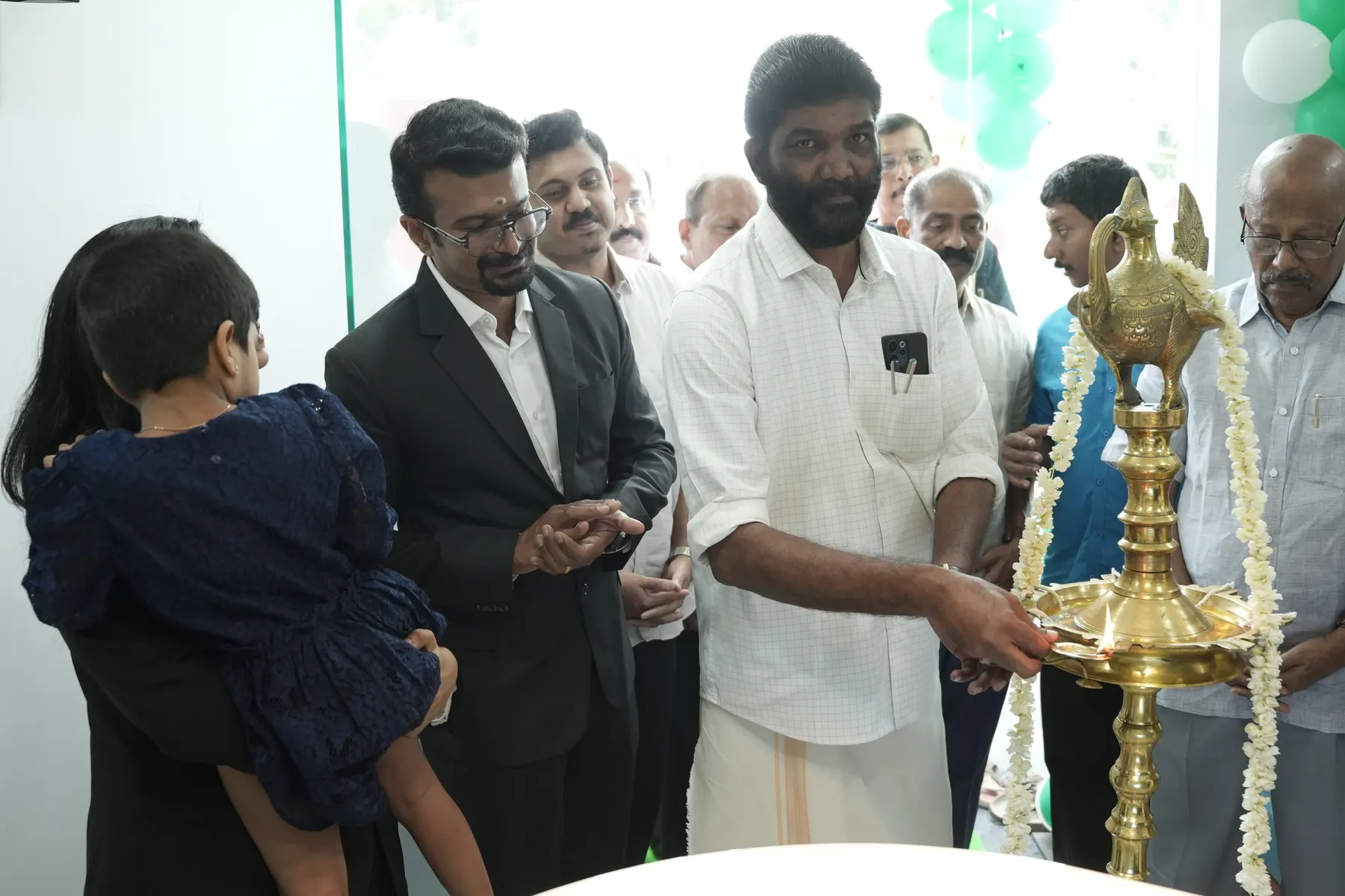 Guests lighting the traditional lamp at the Dental Craft Vanchiyoor opening