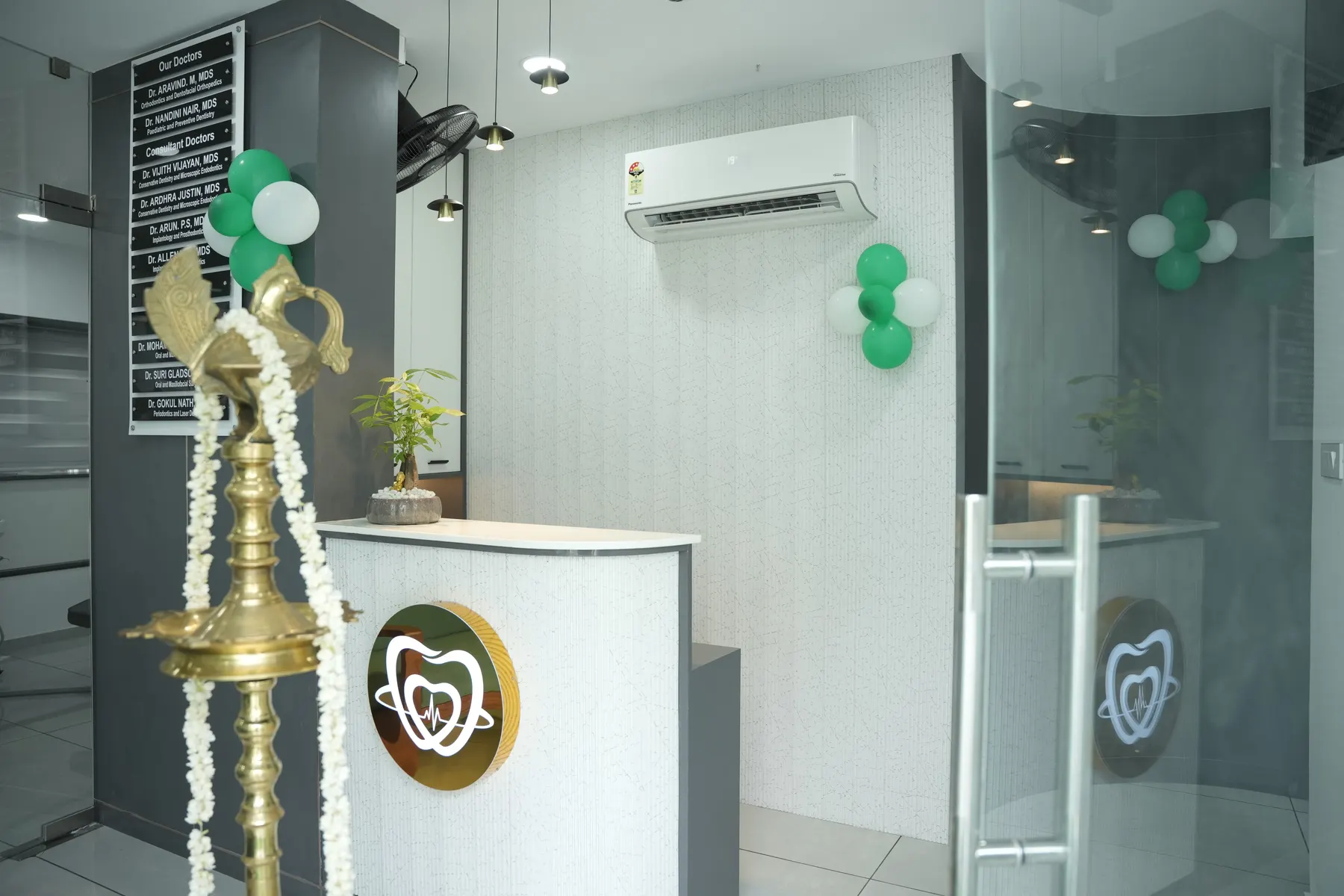 Reception area at Dental Craft Vanchiyoor with the traditional lamp and clinic logo